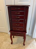 Front view of Jewellery cabinet showing six drawers and elegant Queen Anne legs.
