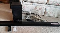 Full view of LG sound bar, subwoofer, remote, and power cables.