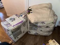 Additional beige woven blanket with pom-pom fringe and folded pillowcases