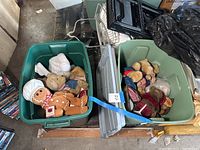Two green plastic bins filled with Boyd Bear collectible stuffed bears including gingerbread man bear and bears in Victorian and other thematic costumes.
