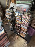 DVD rack with stacked DVDs on left and right sides, assorted genres labeled as His (action, historical) and Hers (romance).