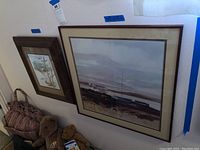 Framed coastal landscape painting with shoreline and water, signed Ackerman, largest approx 22x22 inches.