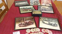 Eight framed 8x10 vintage car photographs, wooden nickels, and a golf treasure box on a red tablecloth