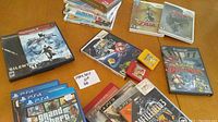 Overview of mixed game cases and cartridges on table