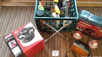 Photo showing the entire lot including lug wrench, car cleaning products in crate, polisher box, jumper cables case, and safety lights laid out on floor