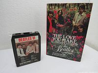 Photo of Beatles VI 8 Track Tape Cartridge beside The Love You Make Beatles book on a flat surface