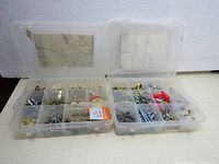 Two plastic storage boxes with organized compartments containing mixed screws and hardware items, shown closed and open.