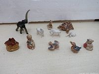 All 11 figurines displayed on a light floor, showing details and size