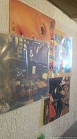 Four vinyl record albums laid flat showing cover art, photographed to detail lot items.