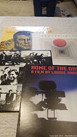 Four vinyl records stacked slightly angled showing front covers with distinct artwork styles.