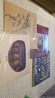 Four vinyl records stacked showing covers of Bob Dylan, Linda Ronstadt, Crosby Stills & Nash, and one with text-heavy blue cover.
