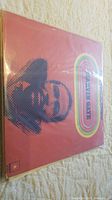 Vinyl LP with red cover featuring stylized Marvin Gaye portrait with rainbow stripes