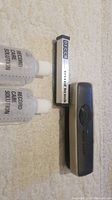 Photo showing two bottles labeled 'Record Care Solution' by Audio-Technica, and two record cleaning brushes including one branded BECCA and the other in a grey Audio-Technica case.
