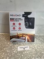 Front view of Reload HD Dash Camera retail box showing camera image and features like 720P HD resolution, continuous loop recording, 2" LCD screen.