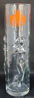 Full view of the tall clear cocktail glass showing embossed female figures on the side, approximately 8.75 inches tall.