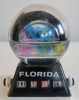 Front view of the water globe showing colorful underwater scene and calendar base with FLORIDA label