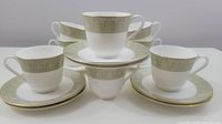 Set of 8 Royal Doulton tea cups and saucers displayed in a group showing the matching design on all pieces.