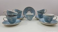 Eight cups and saucers arranged front view
