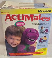 Box of Microsoft ActiMates Interactive Barney plush toy, showing branding and features