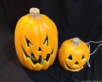 Photo of both large and small jack o lanterns, showing overall size and shape with cords visible.