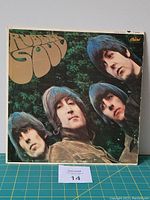 Front cover of The Beatles Rubber Soul album showing the four band members and stylized album title.