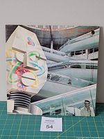 Front cover image showing futuristic robotic and architectural artwork with a punched hole in the jacket.