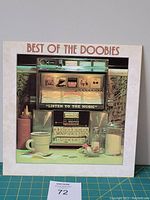 Front cover of The Doobie Brothers 'Best of the Doobies' vinyl LP album featuring a jukebox image and the text 'Listen to the Music'.