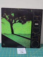 Front album cover showing artwork of tree shadow on green brick wall with title Prelude Deodato.