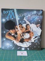 Front cover of Boney M. Midnight Flight to Venus vinyl LP showing band members with cosmic background and title text.