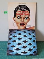 Front covers of two gatefold vinyl LP albums: The Rocky Horror Show with illustrated woman cover, and The Who's Tommy with blue patterned cover.