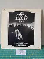 Front cover of the Gregg Allman Tour vinyl LP album showing Gregg Allman performing with orchestra silhouette.