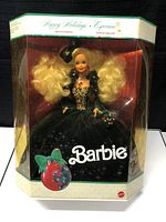 Photo of Barbie doll box showing packaging and doll inside.