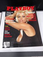 Front cover of a Playboy magazine featuring Elle Macpherson and photo highlights of Pamela Anderson. The cover is glossy with red, white, and yellow text on a black background.