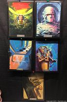 Five framed Goosebumps pictures arranged on display showing various horror-themed illustrations including a bee, mummy, monster, sarcophagus, and a spooky door.