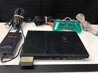 Full set showing PS2 Slim console, controller, power adapter, AV cable, and memory card