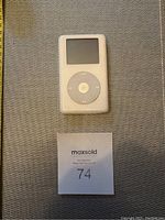 Top view of white Apple iPod showing screen and click wheel with menu and control buttons.