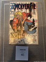 Comic book Wolverine #10 from Marvel Comics displayed face up with clear plastic sleeve and MaxSold lot identifier.
