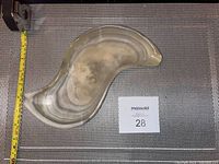 Top view of the quartz ashtray showing the curved kidney-like shape and natural banded quartz pattern.