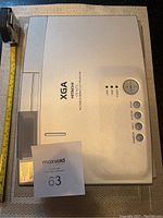 Top view of silver Hitachi XGA multimedia projector showing controls and branding.