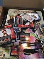Box containing Topps Allen & Ginter 2012 cards with several loose glossy, metallic Skybox Metal cards on top.