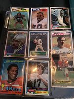 Front side of nine graded NFL football cards from 1970s to 1980s featuring players from Browns, Bills, Cowboys, Eagles, 49ers, Falcons