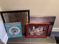 Photo of entire lot showing three framed prints including Disney Snow White lithograph, Edison record print, and a large abstract print.