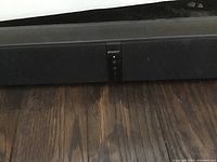 Close-up photo of Energy Power soundbar with central control panel visible.
