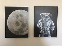 Two black and white space-themed prints hung on a wall showing the moon and an astronaut