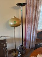 Overview of three lamps: two floor lamps side by side and small table lamp clustered at base