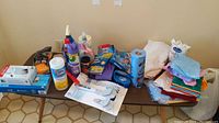Overview photo showing all cleaning supplies, brushes, gloves, towels, and poly rope laid out on a surface.