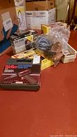 View of lot showing soldering gun kit box, jig saw box, ropes, and other tools on floor