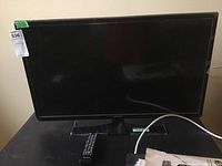 Samsung 32 inch flat screen television on stand viewed from front.