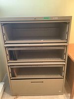Front view of the Commander metal horizontal filing cabinet showing three drawers open and interior rails for horizontal files.