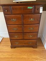 Front view of the full dresser showing five drawers with brass pulls and central lock on the top middle drawer.